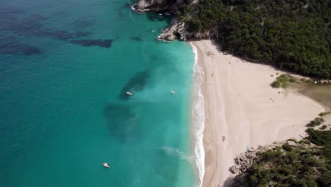 Boats-In-Beautiful-Blue-Sea-At-Cala-Sisine-In-Sardinia,-Italy