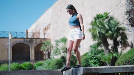 Female-tourist-walk-near-Royal-Palace-of-La-Almudaina-fortress-wall,-Mallorca