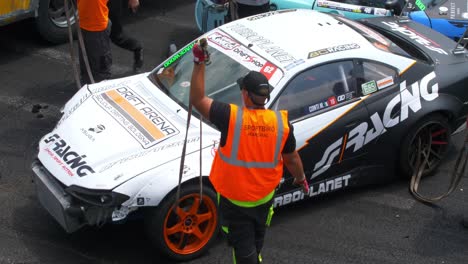 Lifting-one-of-the-crashed-cars-so-it-can-be-removed-from-the-racing-tracks-2