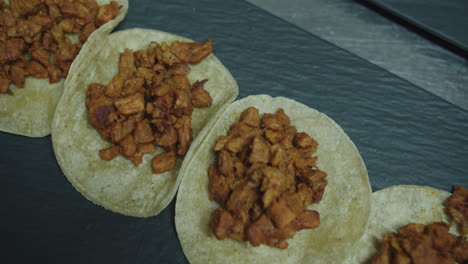 Amazing-slow-motion-shot-of-a-group-of-beef-tacos-in-a-restaurant-kitchen