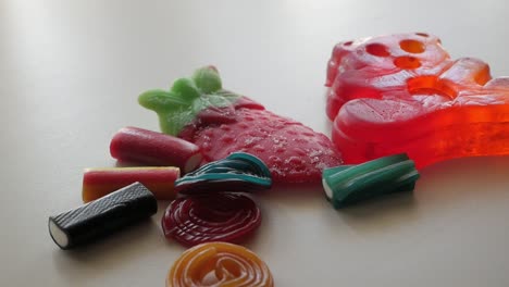 Picking-some-different-colors-jellies-and-licorice-on-a-table-in-studio-enviroment-at-home