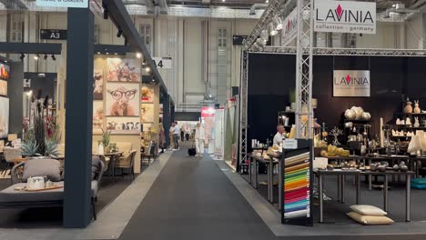 Woman-walking-on-way-inside-hall-for-home-decoration-exhibition-in-Hamburg,-Germany