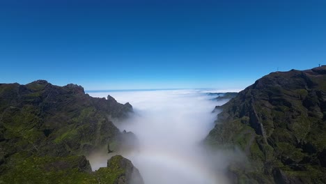 Rainbow-over-clouds-between-peaks-on-Madeira-Island-with-beautiful-blue-sky