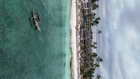 Vertical-drone-shot-of-african-hotel-resort-on-Zanzibar-Island-during-cl0oudy-day