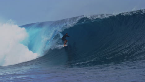 Surfer-stands-upright-and-crouches-down-deep-in-barrel,-slow-motion-Cloudbreak-Fiji