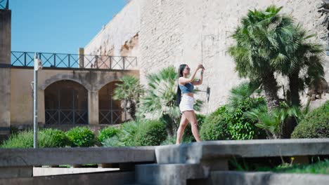 Woman-take-photos-with-phone-near-Royal-Palace-of-La-Almudaina,-Mallorca