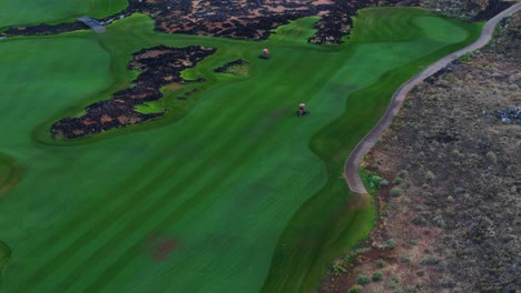 Aerial-footage-of-lawn-mowing-and-course-preparation-at-Black-Desert-Golf-Course-in-Ivins,-Utah