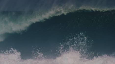 Tracking-pan-follows-ocean-wave-barreling-as-mist-rises-in-tendrils-off-top-of-water-in-slow-motion