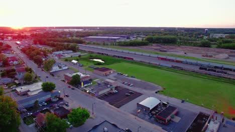 Aerial-shot-of-train-tracks-and-warehouse-area-in-the-city-of-Davenport,-Iowa-at-dusk,-USA