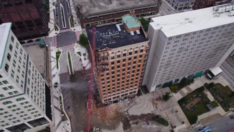 A-top-down-aerial-view-showing-the-demolition-of-a-high-rise-building-in-downtown-Youngstown,-Ohio