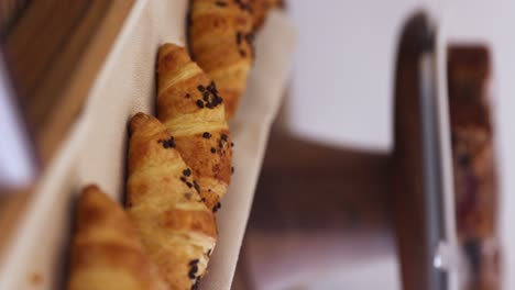 Vertical-View-Of-A-Classic-French-Croissant-Bread-In-A-Bakery