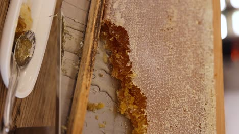 Honeycomb-On-A-Wooden-Frame,-Taken-And-Eaten-Fresh-From-Beehive