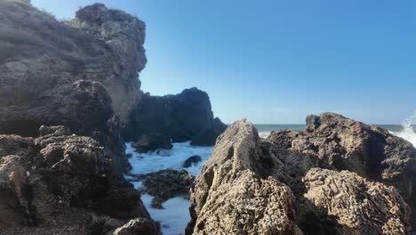 Waves-crash-against-the-rocky-shore-of-Crimea,-highlighting-the-natural-beauty-of-the-Sea-of-Azov-on-a-clear,-sunny-day