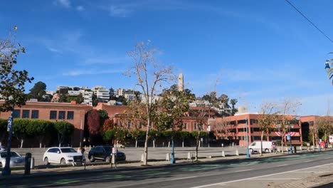 San-Francisco,-California-USA,-Colt-Tower-and-Traffic-on-Embarcadero,-View-From-Moving-Vehicle-on-Sunny-Day