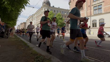 Runners-participate-in-Stockholm-Marathon-on-sunny-day,-slow-motion