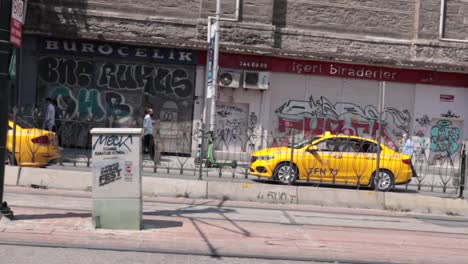 Yellow-taxi-cabs-traverse-the-streets-of-Istanbul,-Turkey,-showcasing-the-dynamic-and-bustling-energy-of-urban-transportation-and-city-life