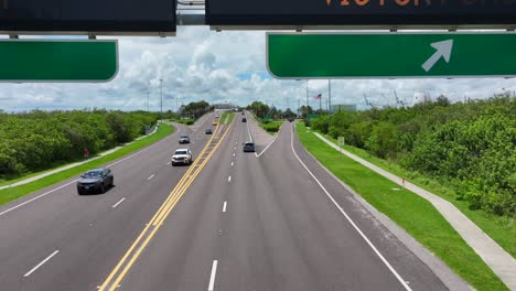 Aerial-forward-shot-of-Port-Canaveral-Street-sign-in-american-highway-in-Florida