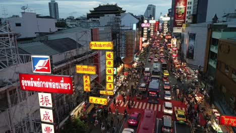 Lebhafte-Chinatown-Straße-Mit-Verkehr,-Tuk-Tuk-Touristen-Straßenimbissständen-Und-Neon-Sing-Luftdrohnenaufnahmen