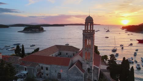 A-drone-orbiting-around-a-church-at-Hvar-island,-Croatia