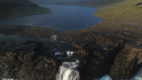 Nature's-Spectacle-in-the-Faroe-Islands:-Waves-and-Sunset-at-Leitisvatn-Waterfall