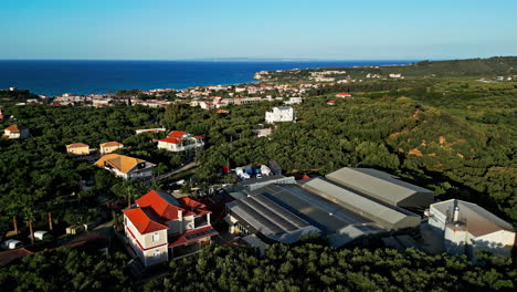 Aerial-drone-establishing-shot-at-beach-seaside-village-of-Greece-clear-daylight