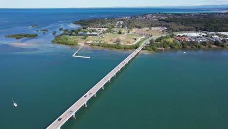 Bribie-Bridge-With-Driving-Cars-In-Bribie-Island,-Queensland,-Australia---Aerial-Drone-Shot