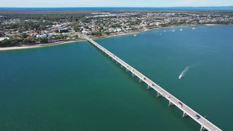 Vehicles-Driving-On-Bribie-Bridge-In-Sandstone-Point,-Queensland,-Australia---Aerial-Drone-Shot