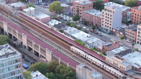 Aerial-view-of-a-subway-train-passing-through-Brooklyn-on-a-summer-day