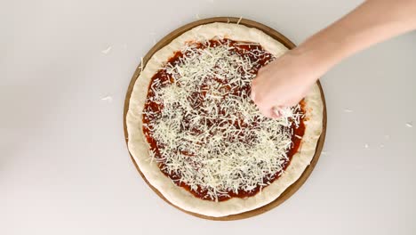 Koch-Verteilt-Käse-Auf-Einem-Pizzaboden