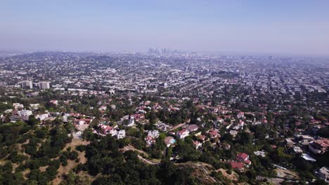 Breathtaking-aerial-footage-capturing-the-sprawling-urban-landscape-of-Los-Angeles-as-seen-from-Griffith-Park,-highlighting-the-city's-vastness-and-diverse-neighborhoods