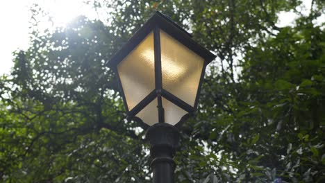 Slow-orbiting-shot-of-a-led-lamp-lighting-the-path-in-a-park