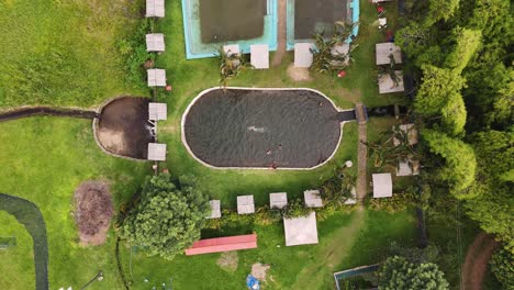 People-having-fun-swimming-in-a-natural-lagoon-near-Pance-River-in-Cali,-Colombia,-slow-motion