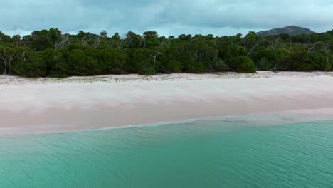 Whitehaven-Beach-bush-white-sand-aerial-drone-Whitsundays-Island-Airlie-National-Park-Australia-AUS-QLD-rain-cloudy-blue-sky-outer-Great-Barrier-Reef-clear-blue-aqua-ocean-boat-yachts-static-shot