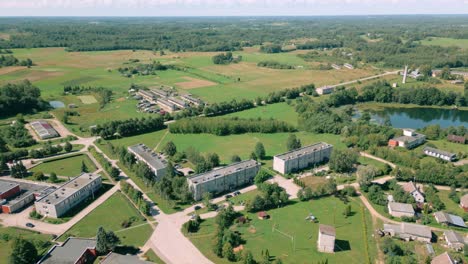 Aerial-footage-of-Soviet-era-concrete-apartment-blocks-in-Baltic-landscape-during-summer