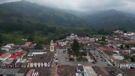 Aerial-orbits-town-of-Salento-in-misty-green-mountains-of-Colombia