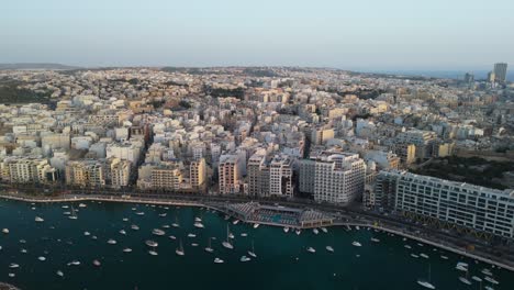 Sunrise-drone-flight-over-Sliema,-Malta-with-clear-sky