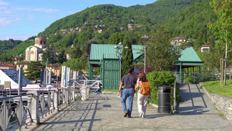 Tourists-Strolling-On-Lakefront-Promenade-Of-Laveno-Mombello-In-Varese-province,-Lake-Maggiore,-Lombardy,-Italy