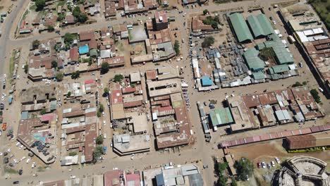 Reveal-urban-landscape-of-African-town-at-footstep-of-Kilimanjaro,-Kenya,-aerial