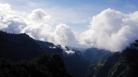 Flying-over-a-steep-mountain-range-with-clouds-on-top