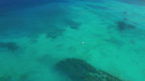 Aerial-view-above-boats-in-a-turquoise-blue-water