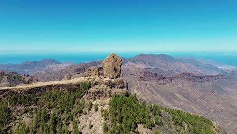 Aerial-view-of-people-hiking-in-Gran-Canaria-at-Roque-Nublo-mountain-geologic-rock-formation