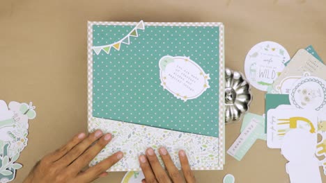 Designing-cover-of-scrapbook-album-with-cutouts-and-colorful-decorations-to-create-unique-look-tutorial