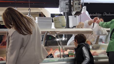 Customers-Buy-Meat-At-Butcher-Shop-In-Provencal-Market,-Antibes,-France