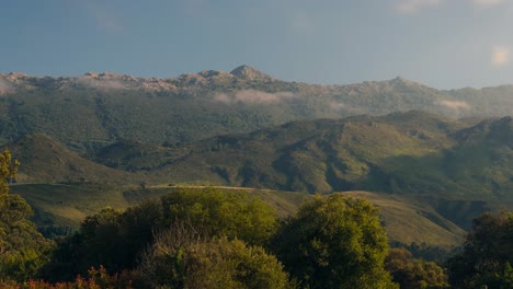 Sierra-de-Cuera-view-from-Andrin,-llanes-during-a-sunny-afternoon-with-low-clouds-and-beautiful-light-playing-with-the-mountains