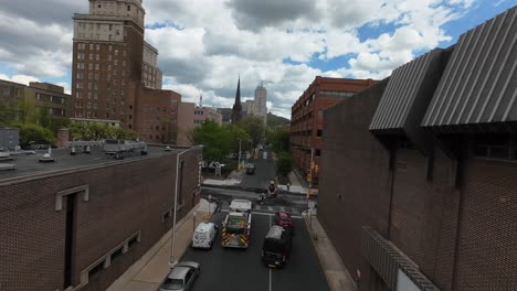 Aerial-tracking-shot-of-garbage-truck-on-street-of-american-town