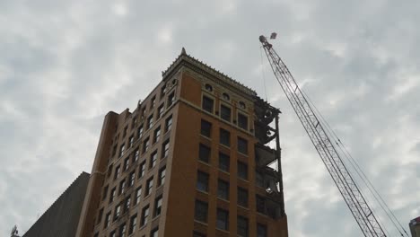 The-top-floors-of-a-high-rise-building-in-Youngstown,-Ohio,-are-being-demolished