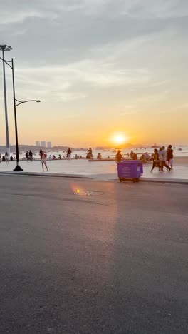 In-the-evening-sunset-is-setting-on-the-seed-and-many-are-getting-into-their-taxis-and-leaving