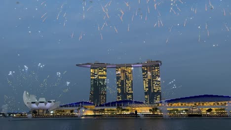 Hermosos-Fuegos-Artificiales-Lanzados-Al-Cielo-Durante-El-Desfile-De-Ensayos-Del-Día-Nacional-Y-Contra-El-Famoso-Fondo-Arquitectónico-De-Marina-Bay-Sands,-Singapur.