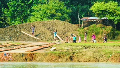 Brick-Field-Workers-Carrying-Soil-in-Baskets-over-Their-Heads