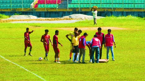 Junior-football-team-warming-up-on-a-sunny-day-in-Bangladesh,-getting-ready-for-a-match